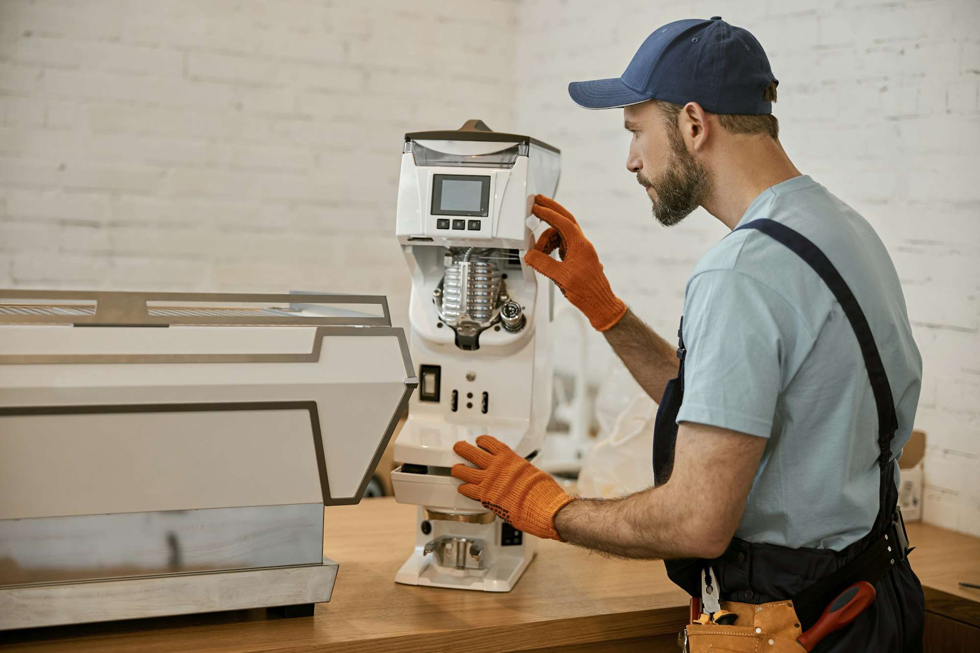Specialist Technician Servicing Professional Espresso Equipment in Commercial Setting