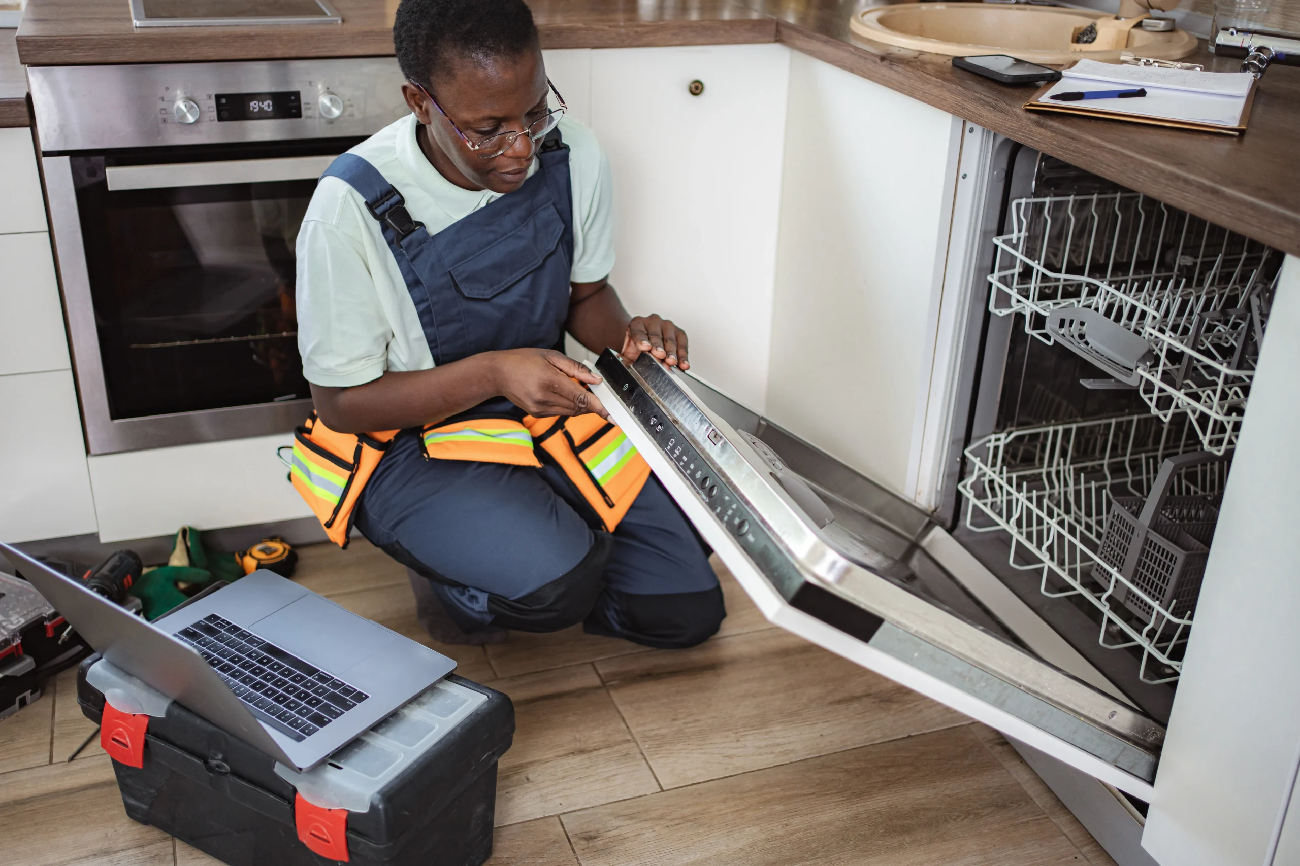 Appliance Repair Specialist Inspecting Internal Dishwasher & Washer Components